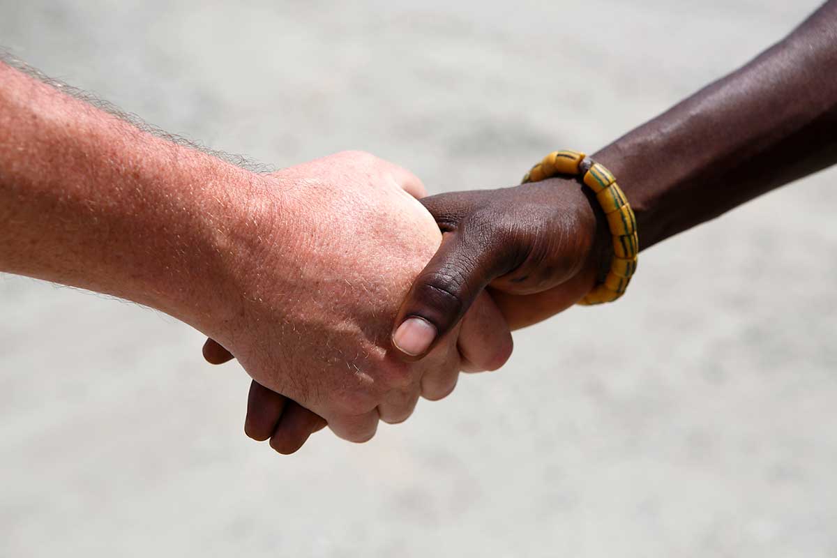 A close up photo of two people handshaking in Ghana, Africa.