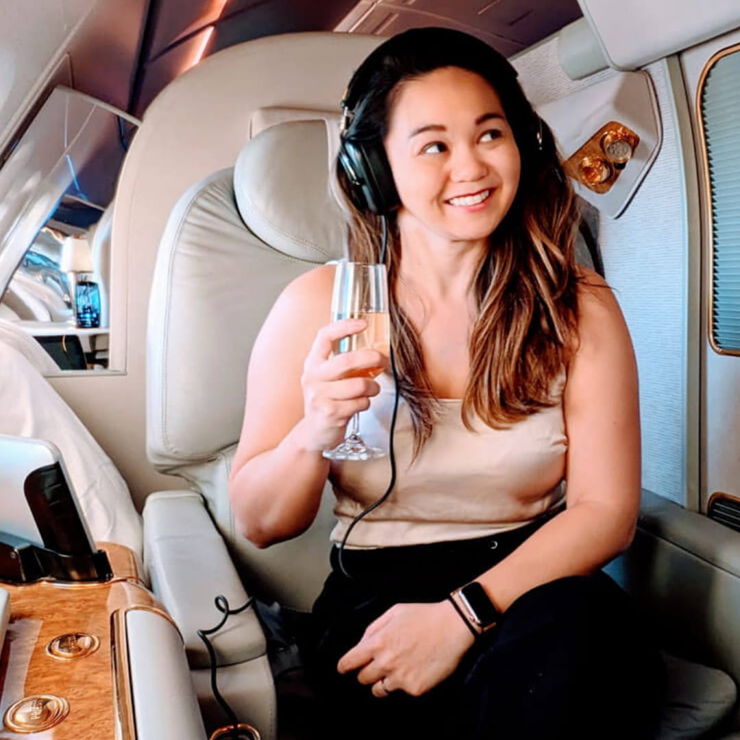 Patreon Creator Julia Menez flying first class using miles and points strategies she teaches in her membership