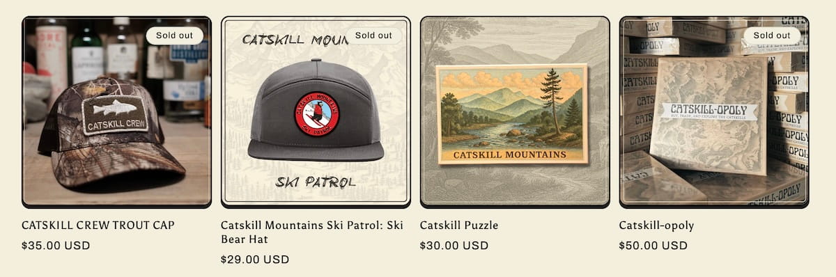 A row of four product listings from the Catskill Crew shop displays various ways the brand monetizes through physical goods. The first item is a camouflage "Catskill Crew Trout Cap" priced at $35.00, marked as sold out. The second is a gray "Catskill Mountains Ski Patrol" hat for $29.00, also sold out. The third listing shows a "Catskill Puzzle" for $30.00, featuring a vintage-style landscape illustration of a river and mountains. The final item is "Catskill-opoly," a custom board game priced at $50.00, shown with a stack of game boxes in the background and a sold out tag.