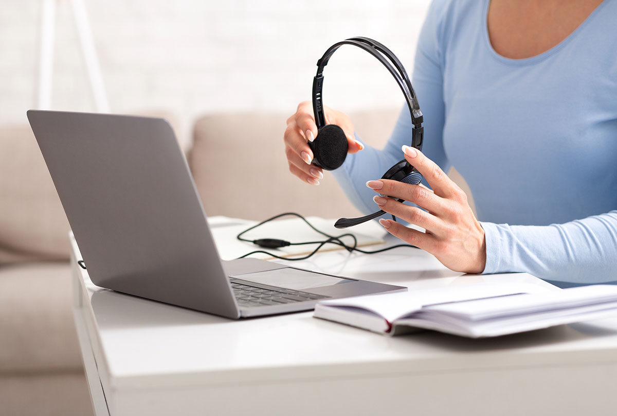 Putting headphones before a Preply language lesson.