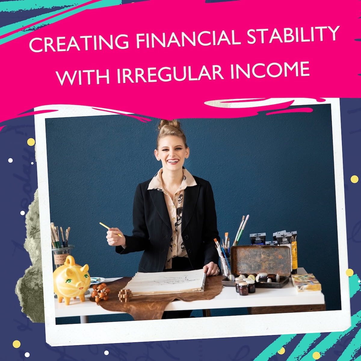 A promotional graphic for the Profitable Travel Blogger Podcast. The background features dark navy, teal, and bright pink brushstrokes with white dots. In the center, a Polaroid-style photo shows a smiling woman with her hair styled in a high bun, wearing a black blazer over a patterned collared shirt, standing behind a desk in front of a dark blue wall. On the desk are artist supplies, paintbrushes, paint tubes, an open sketchbook, and a bright yellow piggy bank. A vibrant pink banner across the top reads "CREATING FINANCIAL STABILITY WITH IRREGULAR INCOME" in bold white text.