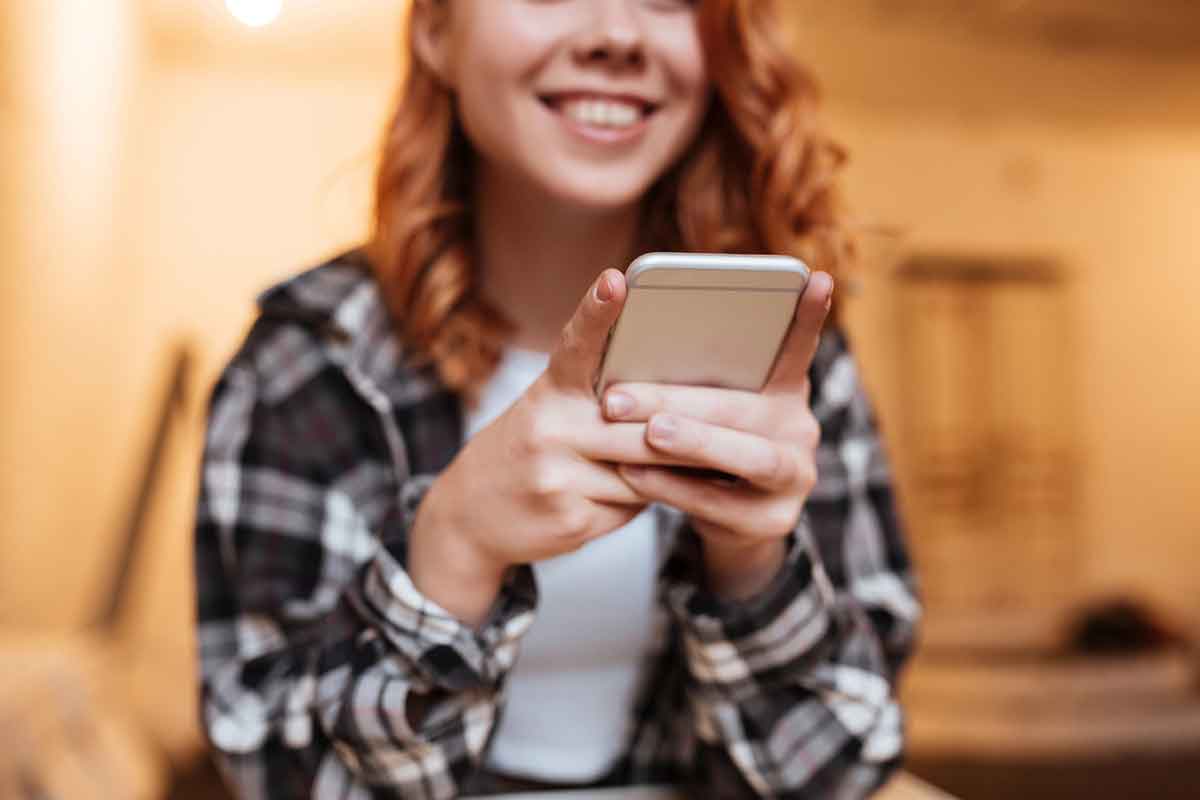 Cropped photo of cheerful redhead young lady on social media.