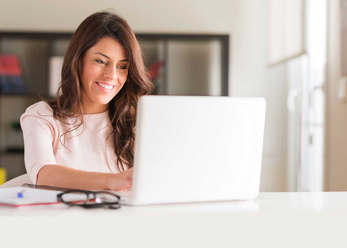 Woman giving a webinar on her laptop as part of her monetization system.