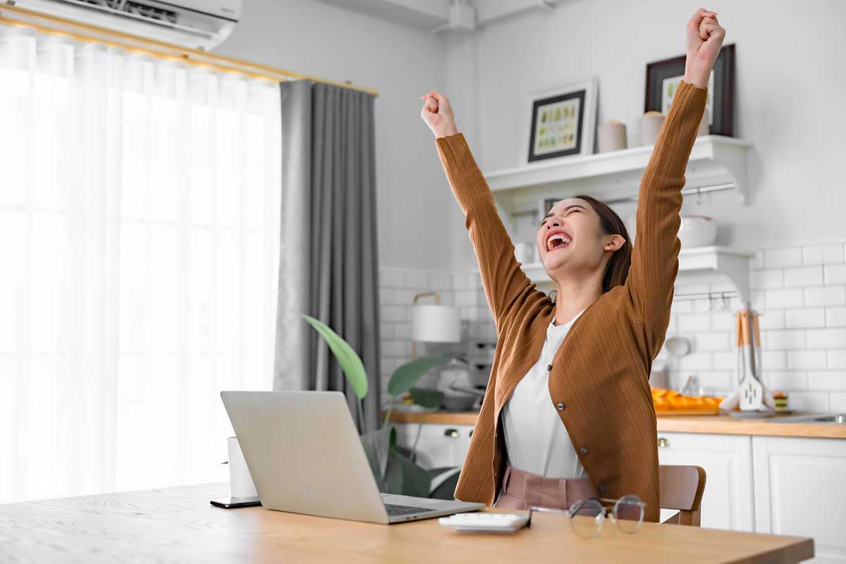 Euphoric young asian woman celebrating winning a giveaway.