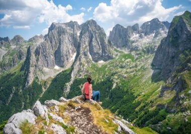 woman admiring the view in Prokletije National Park while hiking the Peaks of the Balkans trail